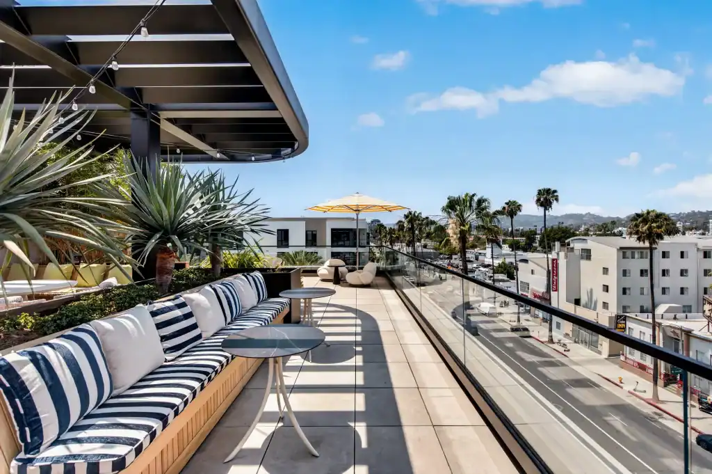 Outdoor rooftop lounge with stylish seating and ocean views.